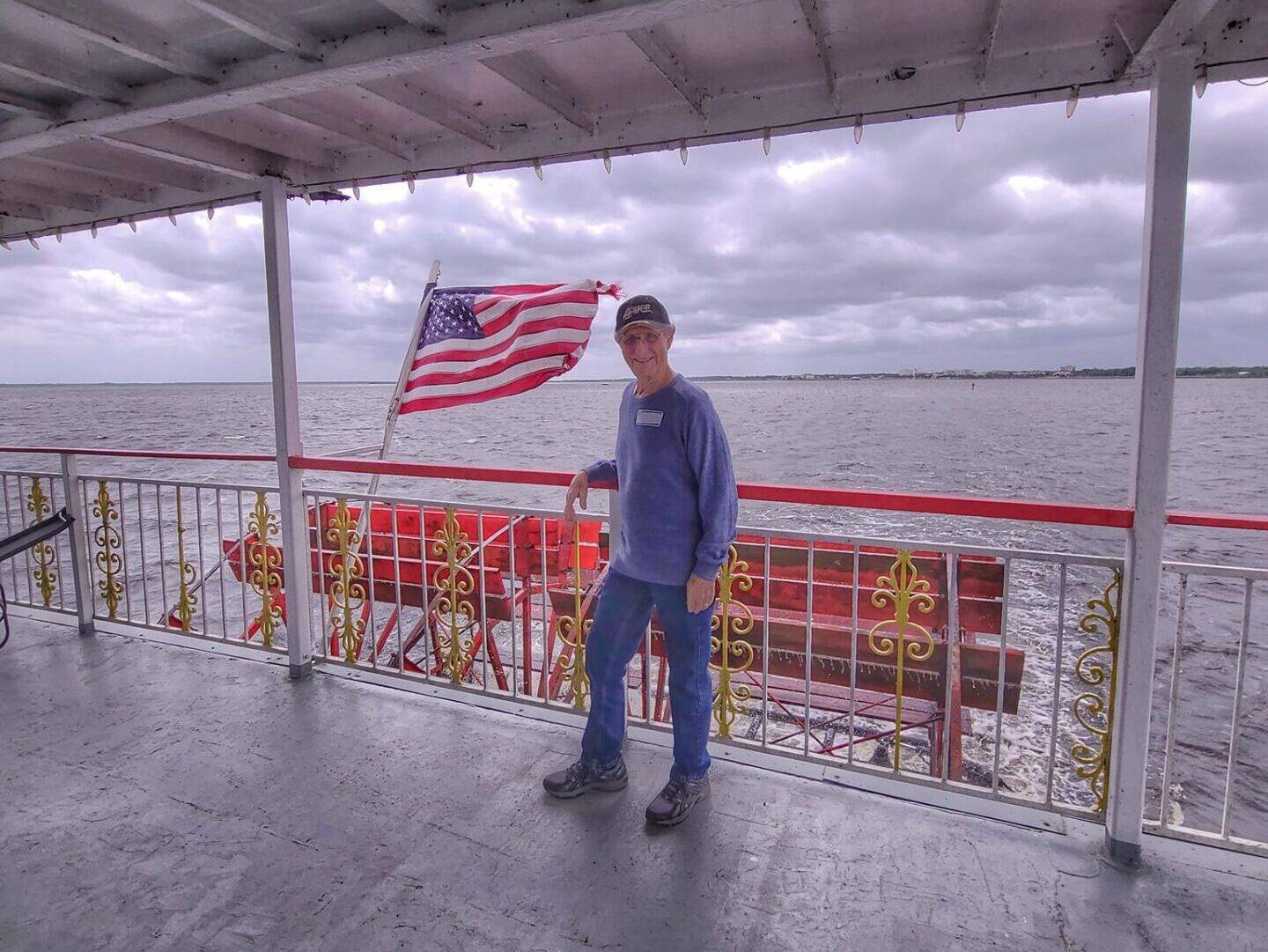 LIFE member standing on the deck of the Sanford River Boat